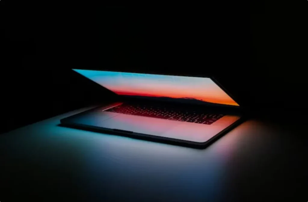 half-open laptop in dark room